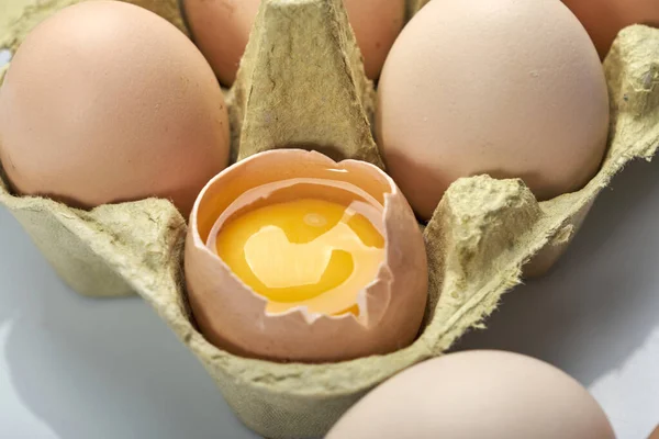 Close-up of eggs in cartoon on white background. Raw chicken eggs in egg box organic food for good health high protein .