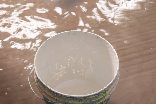 white colored plastic paint on pot for sealing paint