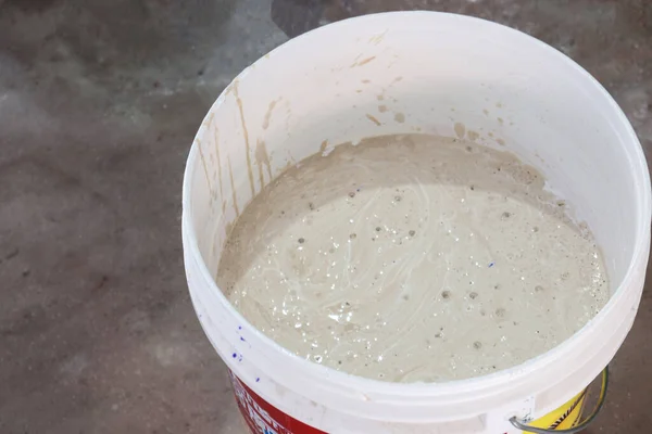 white colored plastic paint on pot for sealing paint
