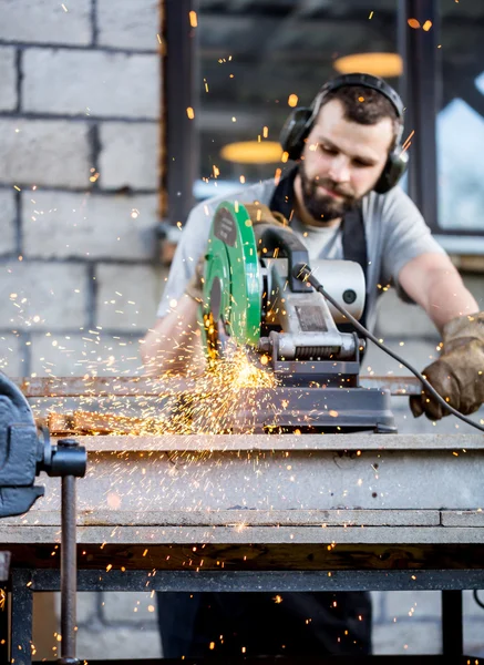 Industrial worker cutting metal