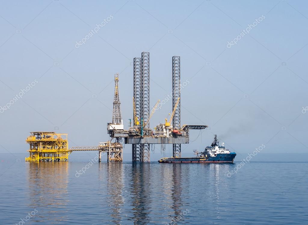 Drilling rig and supply boat — Stock Photo © look_67 75485511