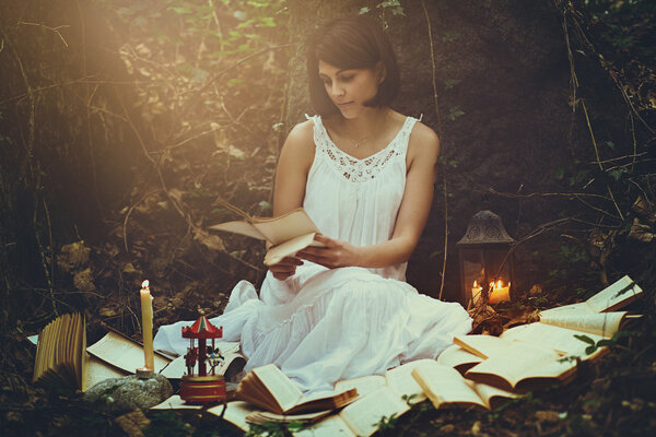 Romantic and surreal portrait of a woman in a forest