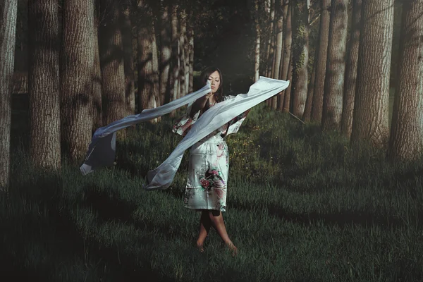 Beautiful woman dancing in ethereal forest — Stock Photo, Image
