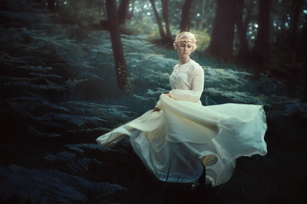 Ethereal woman dancing in dreamy forest Stock Picture