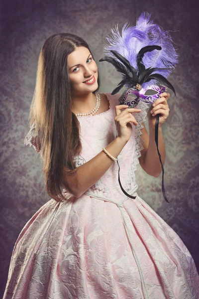 Smiling woman with purple venetian mask — Stock Photo, Image