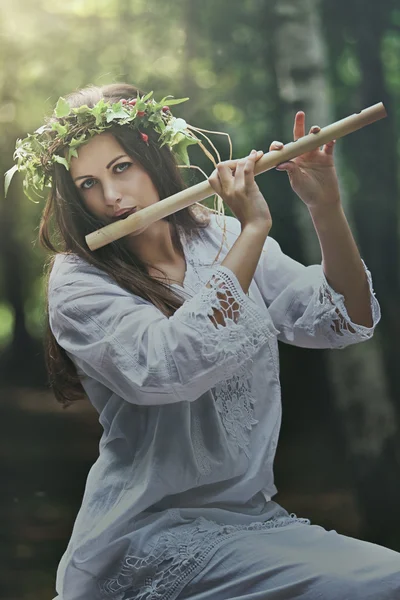 Dark forest nymph with a flute — Stock Photo, Image