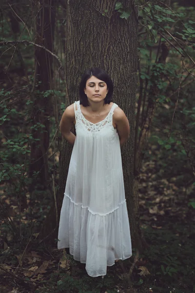 Beautiful woman with eyes closed in the wood — Stock Photo, Image