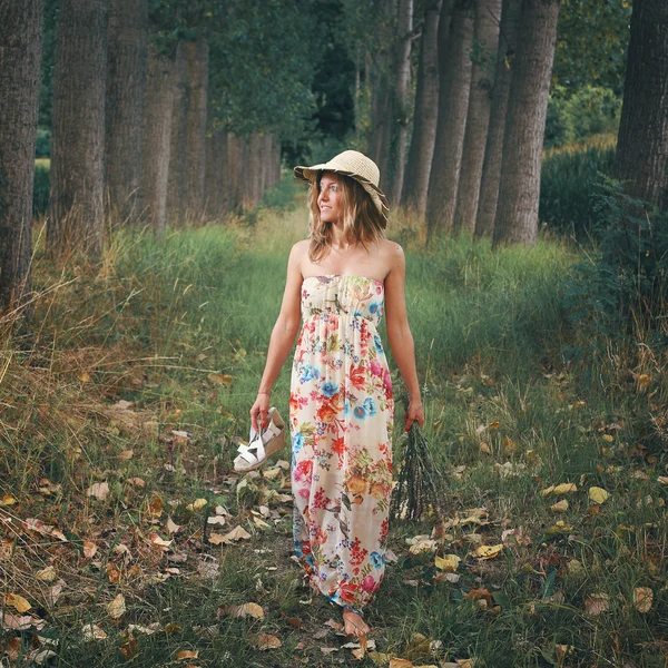 Beautiful woman walking barefooted in nature Stock Picture