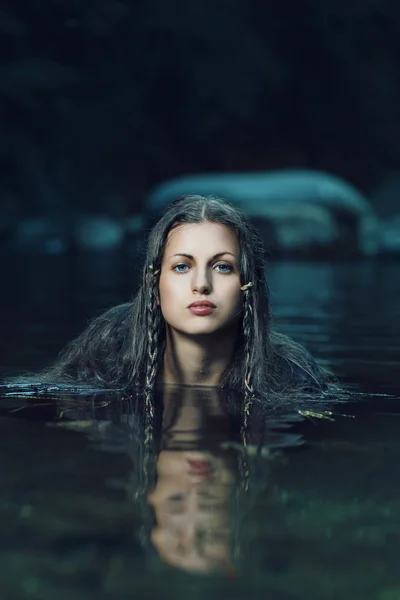 Beautiful water nymph in dark cyan stream — Stock Photo, Image