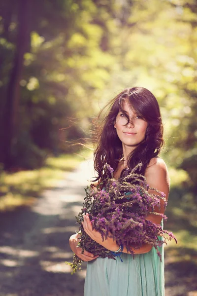 Beautiful woman with wild flowers — Stock Photo, Image