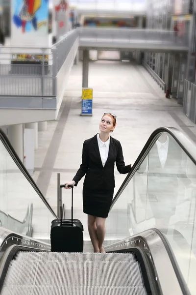 Businesswoman in modern train station hall — Stock Photo, Image