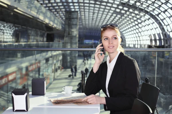 Beautiful business woman in train station hall — Stock Photo, Image