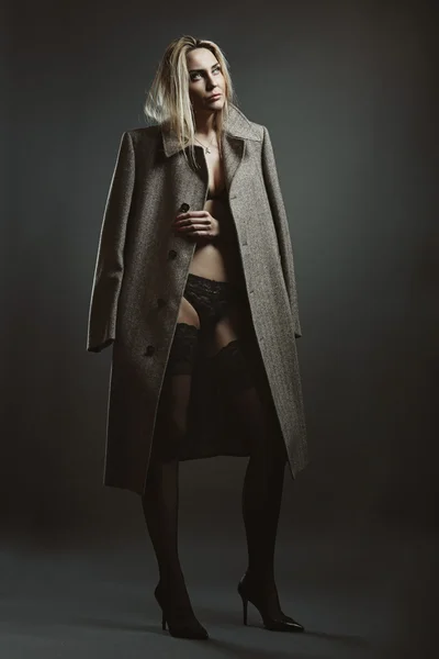 Чувственная модель в нижнем белье и пальто — стоковое фото