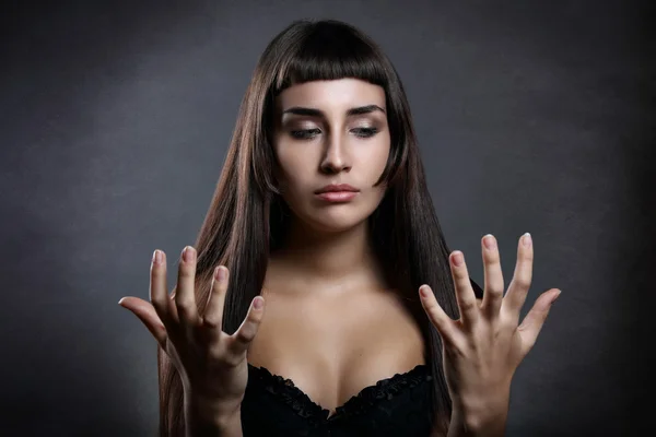 Beautiful woman looking at her hands — Stock Photo, Image