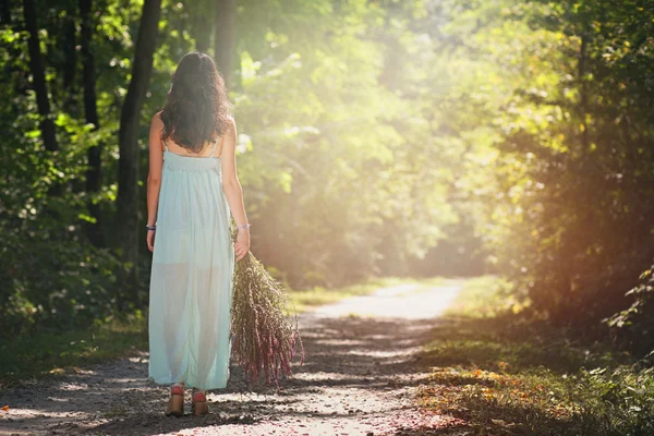 Beautiful woman walking forest path — Stock Photo, Image