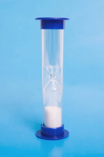 Medical hourglass on a blue background closeup Stock Photo