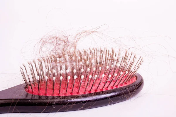 Comb and hair on white background, alopecia — Stock Photo, Image