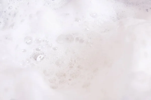 Bubbles in white foam close up, background or texture