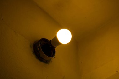 Odanın köşesinde sarı ampul var.