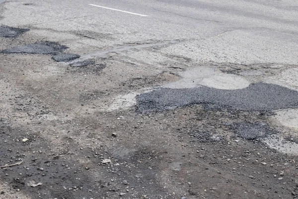 Holes in road are filled with stones