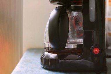 Mutfak masasındaki sade kahve makinesi, boşluğu kopyala