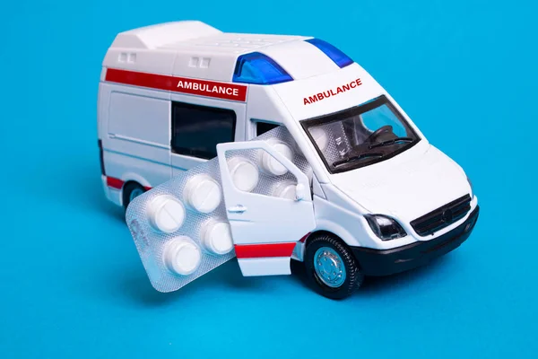 Juguete Ambulancia Coche Píldora Sobre Fondo Azul Cerca —  Fotos de Stock