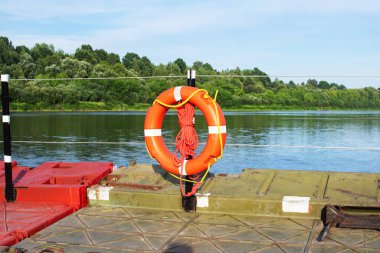 Nehrin kıyısındaki iskelenin çitlerinde can simidi