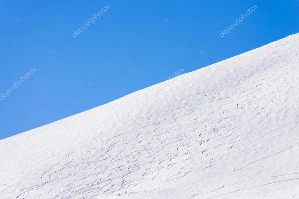 ski slope with ski tracks