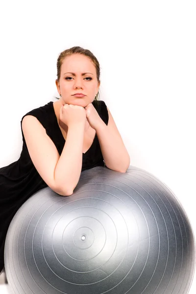 Determined woman leaning over a pilates ball — Stock Photo, Image