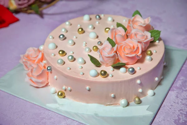 Orange round cake. Orange golden rose. Round ball decorated like a round pearl.