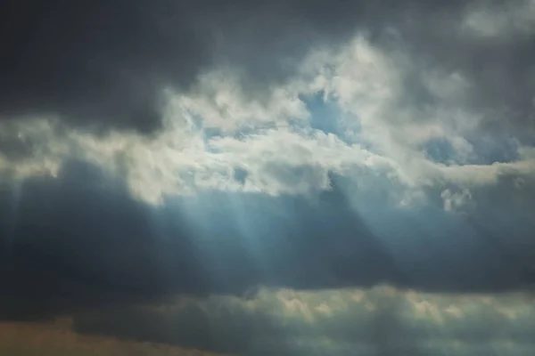 Stock image the rays of the sun among the clouds of the sky . RAY OF SUNLIGHT ESCAPING AMONG THE CLOUDS . Sky with sun rays among the clouds.