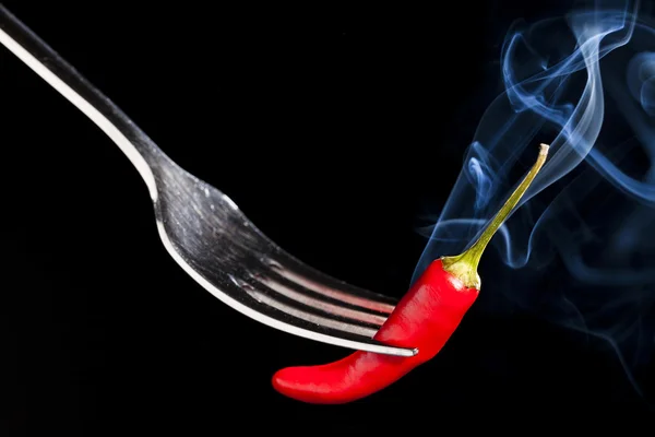 Red hot pepper on a fork with smoke — Stock Photo, Image