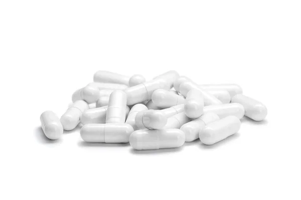 Zbliżenie stos białych kolorowych tabletek lub kapsułek na izolowanym białym tle. Skupienie selektywne. — Zdjęcie stockowe