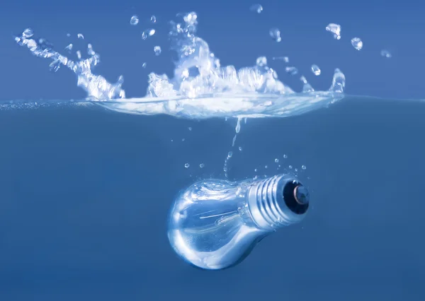 Electric bulb in water splashes — Stock Photo, Image