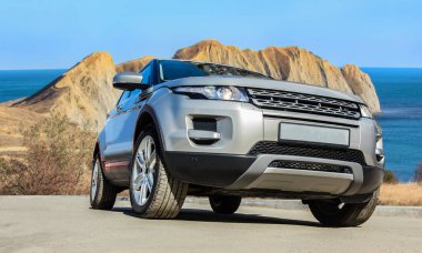 SUV deniz kıyısının yakınındaki yolda ilerliyor.