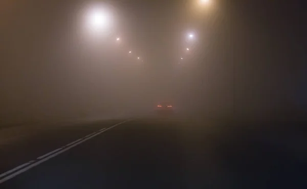 乡间道路上被路灯点亮的浓雾 — 图库照片