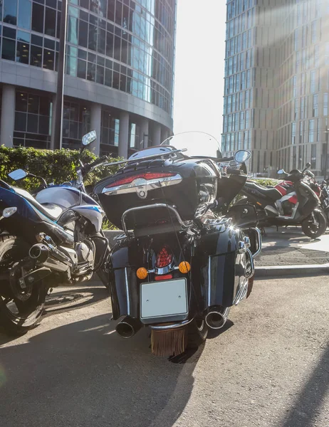 Motorcycles and cars in the parking lot in the downtown