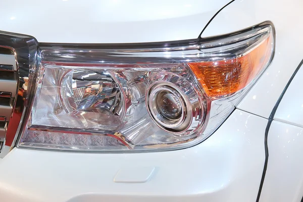 Headlight of white car close up — Stockfoto