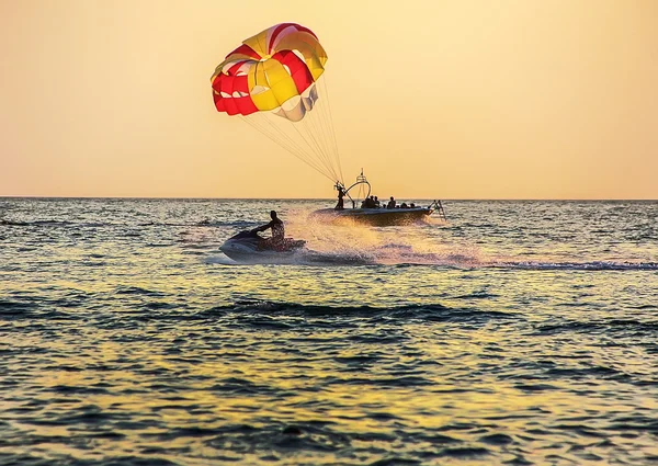 Boat with parachute and water bike at sea — Stock Photo, Image