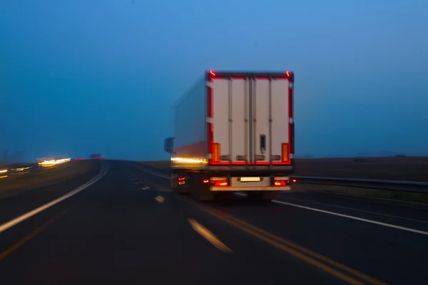 Samochód porusza się na autostradzie w nocy — Zdjęcie stockowe