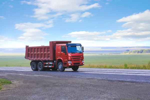 Dump truck goes on country highway — Stock Photo, Image