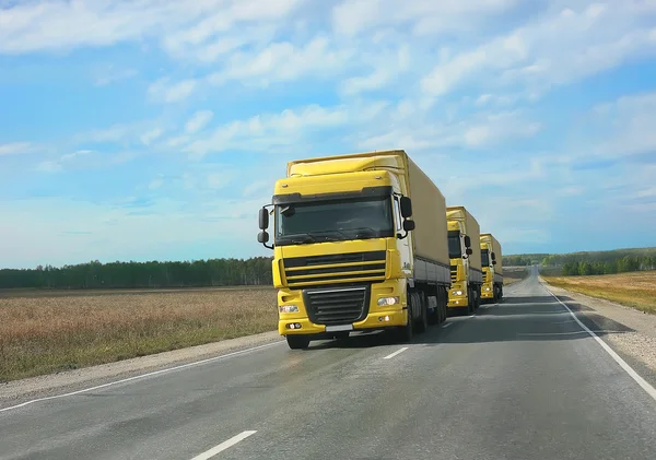 Escort of yellow trucks — Stock Photo, Image