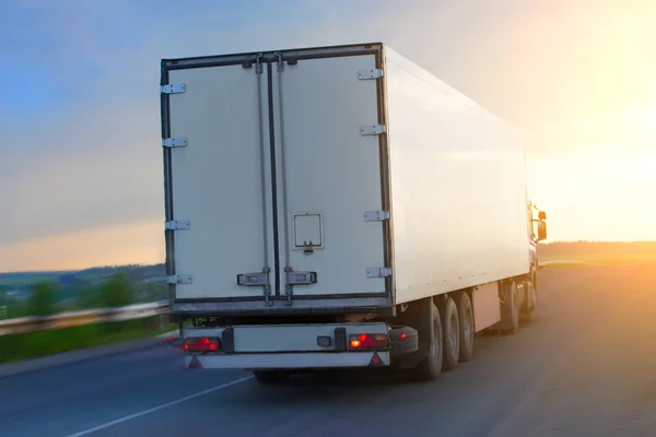 Truck moves on highway at sunrise — Stock Photo, Image