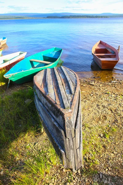 Wooden boats on bank of lake — Stock Photo, Image