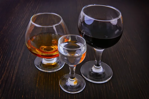 Cognac vodka wine in three glasses — Stock Photo, Image