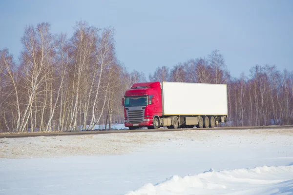 Truck goes on winter snow highway — Stock Photo, Image