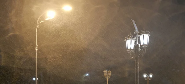 street lamp at night in winter during heavy snow close up