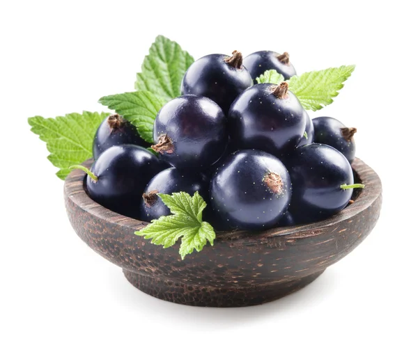 Black currant in wooden plate — Stock Photo, Image