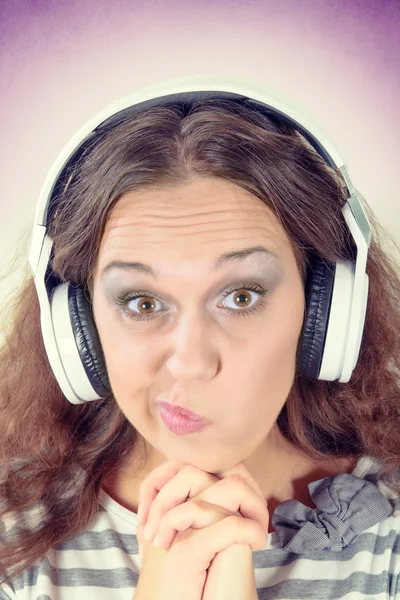 Female with funny expression and headphones — Stock Photo, Image