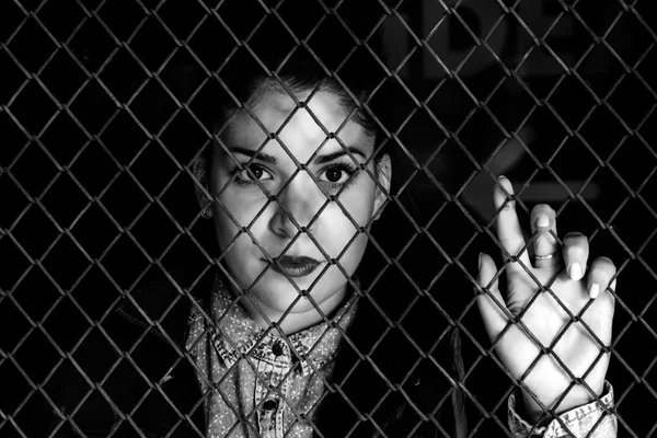 Loceked female behind metal wire — Stock Photo, Image